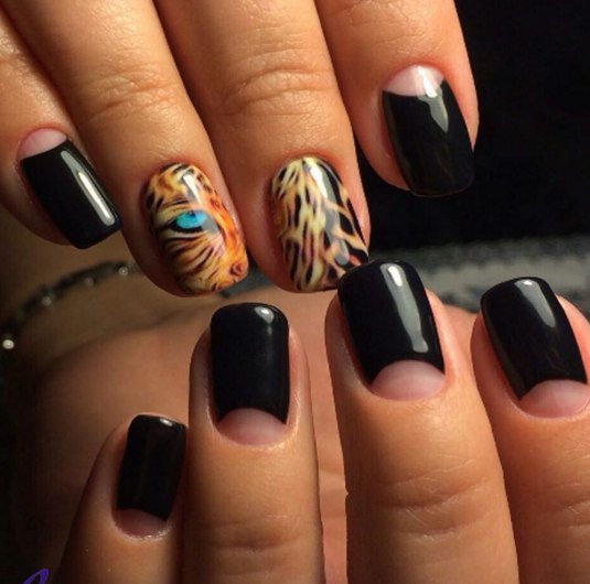 Чорний манікюр з помаранчевими акцентами: максималізм та ручний розпис