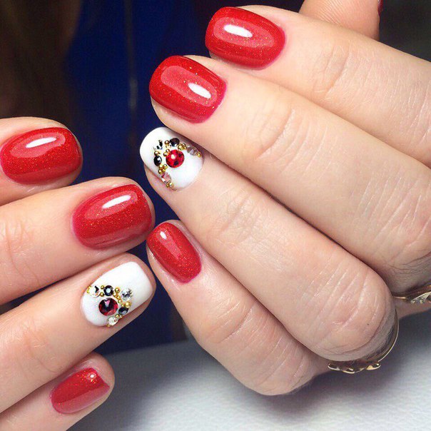 Червоний святковий манікюр з блискучими стразами та золотом