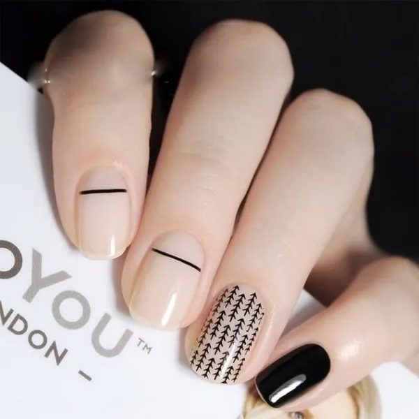 Бежевий мінімалізм: чорна геометрія на овальних нігтях