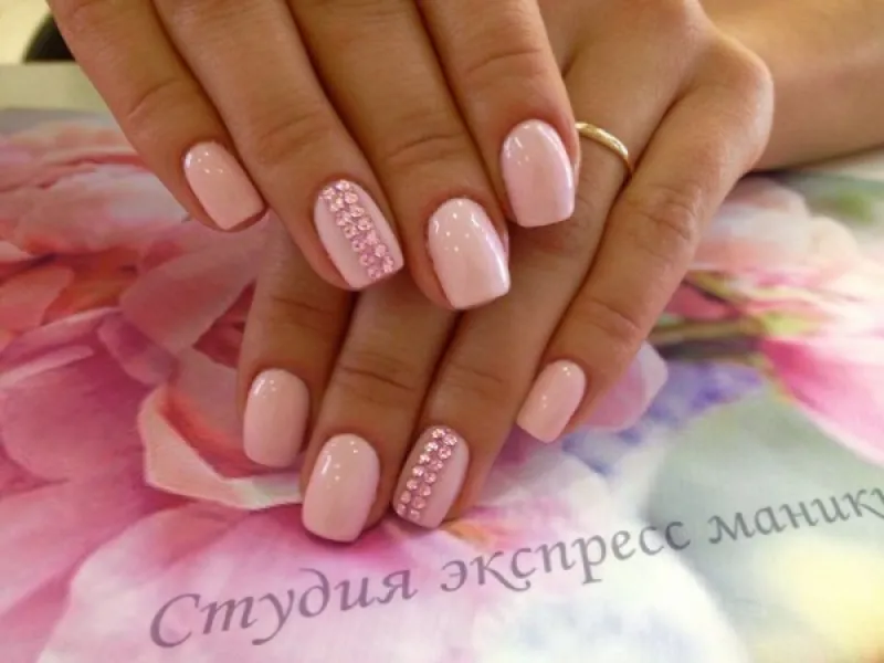 Рожевий мінімалізм з блиском: овальні нігті зі стразами